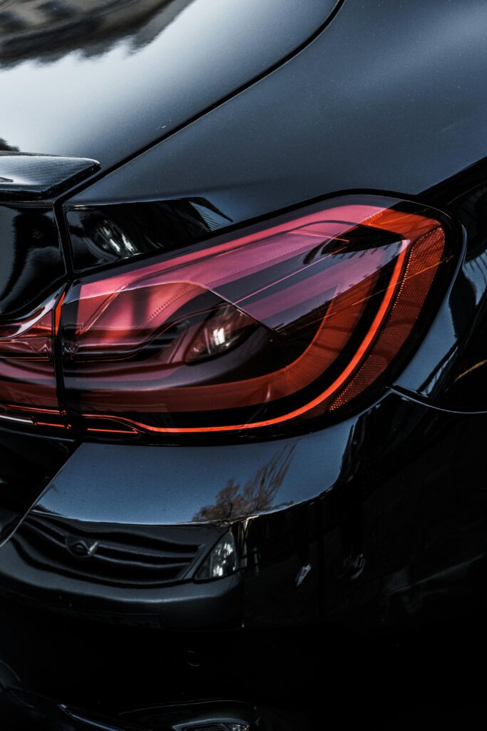 Detailed shot of a black car's taillight in Sochi, highlighting modern automotive design.